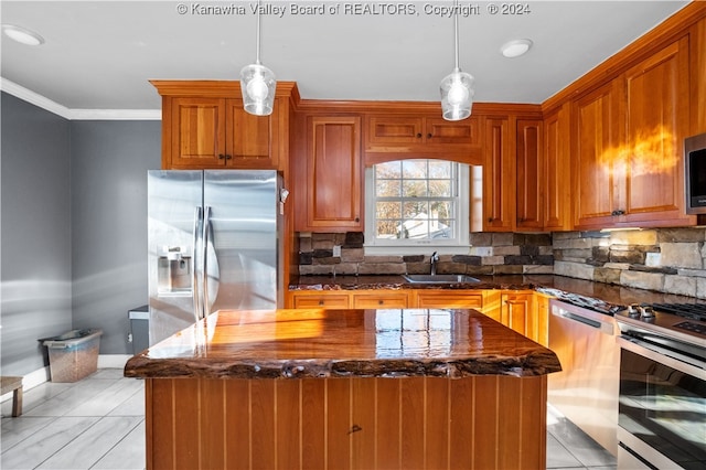 kitchen with dark stone countertops, a center island, stainless steel appliances, and sink