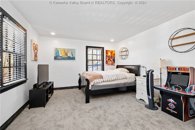 bedroom featuring light carpet