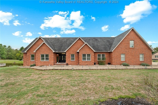 rear view of house featuring a patio and a yard