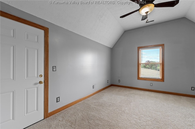 bonus room featuring ceiling fan, a textured ceiling, lofted ceiling, and carpet