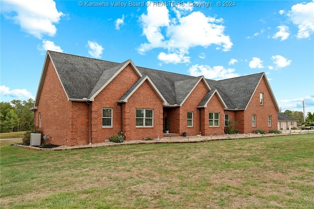 view of front of property with a front yard and central air condition unit