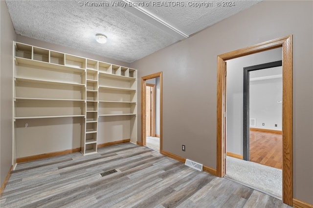 spacious closet with light hardwood / wood-style floors