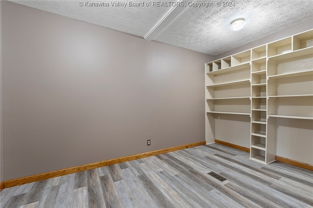 interior space featuring a textured ceiling and light hardwood / wood-style flooring