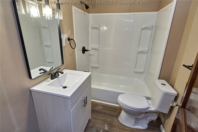 full bathroom featuring wood-type flooring, shower / bathing tub combination, vanity, and toilet