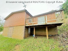 rear view of property featuring a wooden deck