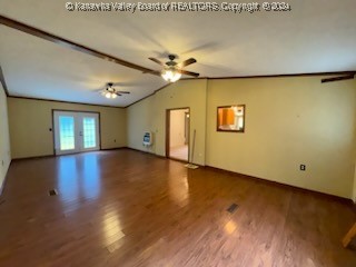 empty room with ceiling fan and hardwood / wood-style floors