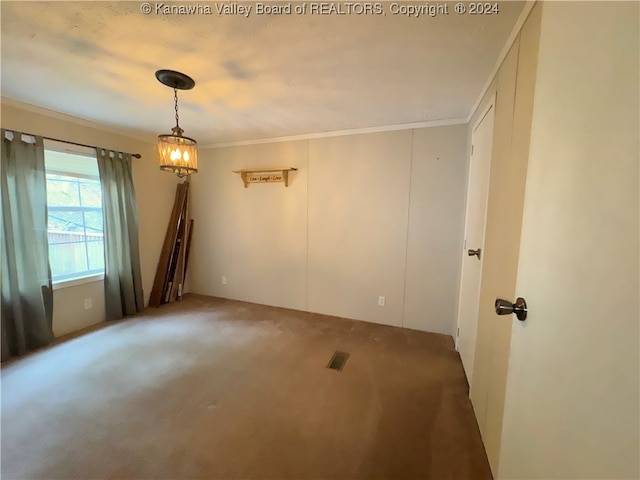 spare room with ornamental molding, a textured ceiling, and carpet floors