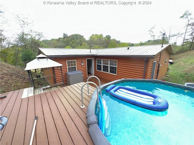 view of swimming pool featuring a deck