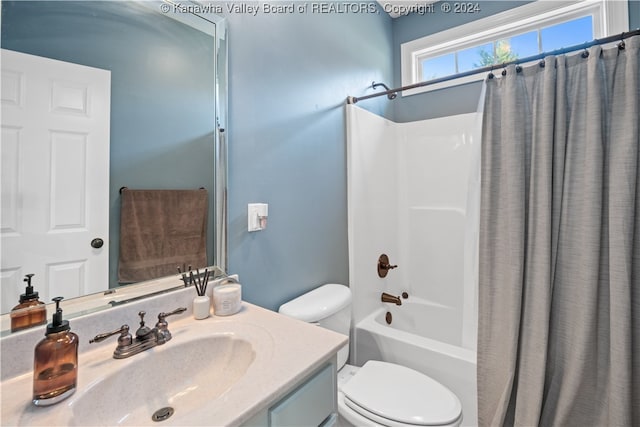 full bathroom with vanity, shower / bath combo with shower curtain, and toilet