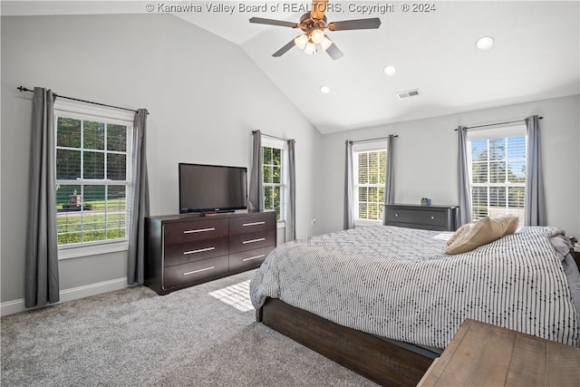 carpeted bedroom with ceiling fan and high vaulted ceiling