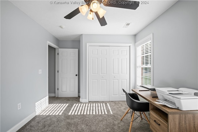 carpeted office space featuring ceiling fan