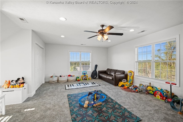 playroom with carpet floors and ceiling fan