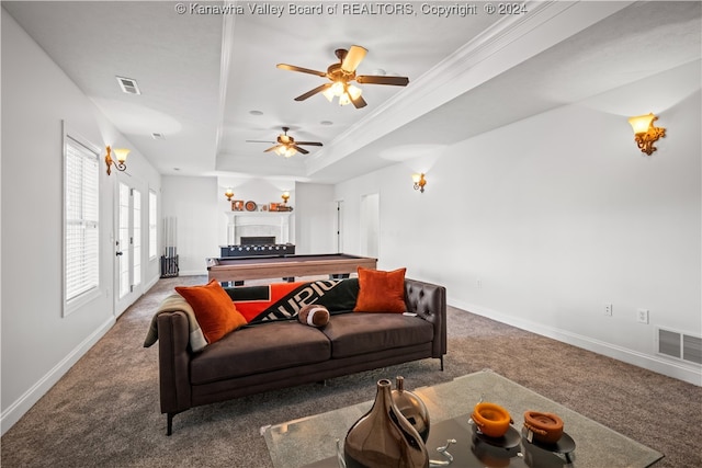 living room featuring a tray ceiling, carpet flooring, ornamental molding, ceiling fan, and french doors