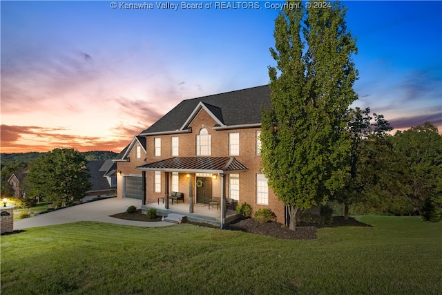 view of front of home featuring a garage and a lawn