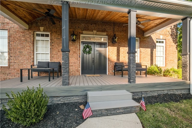 property entrance featuring a porch and ceiling fan