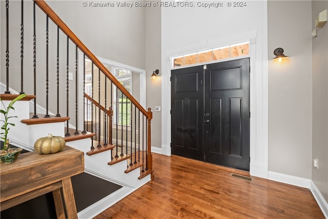 entrance foyer featuring a high ceiling and hardwood / wood-style flooring