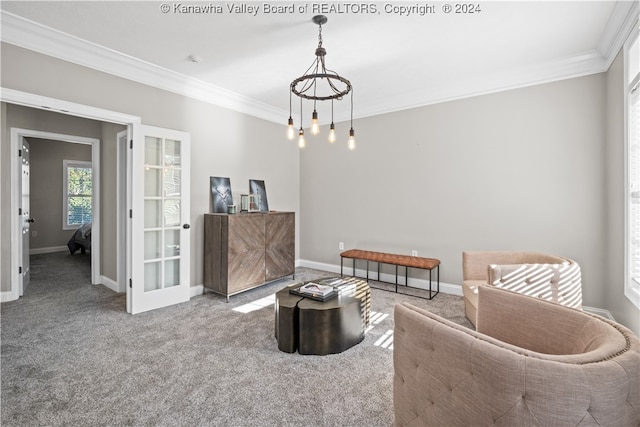 sitting room with ornamental molding, a chandelier, and carpet floors