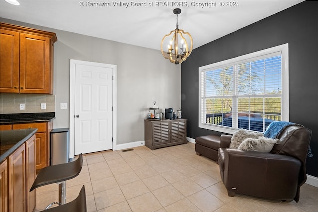 living area featuring an inviting chandelier and light tile patterned floors