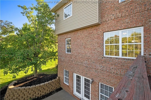 view of side of home featuring brick siding