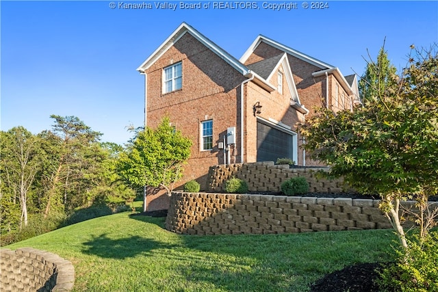 view of home's exterior with a garage and a yard