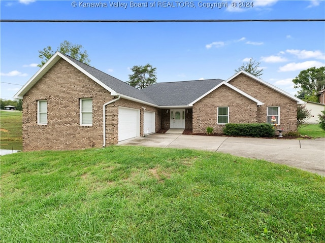 single story home with a front yard and a garage