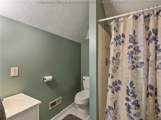 bathroom with tile patterned floors, toilet, a shower with shower curtain, vanity, and a textured ceiling