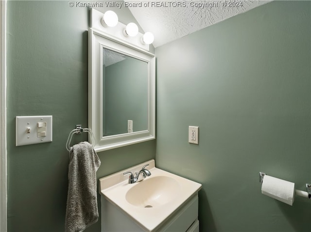 bathroom featuring vanity and a textured ceiling