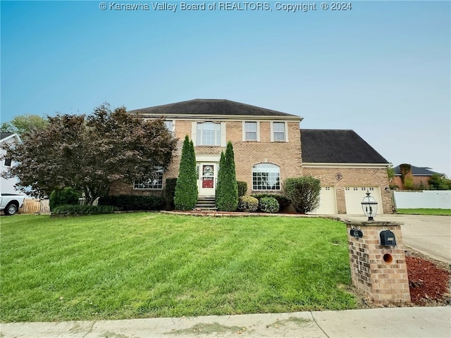 view of front of property with a front lawn and a garage