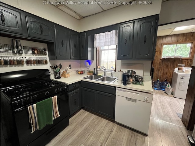 kitchen with washer / clothes dryer, white dishwasher, light wood-type flooring, gas stove, and sink