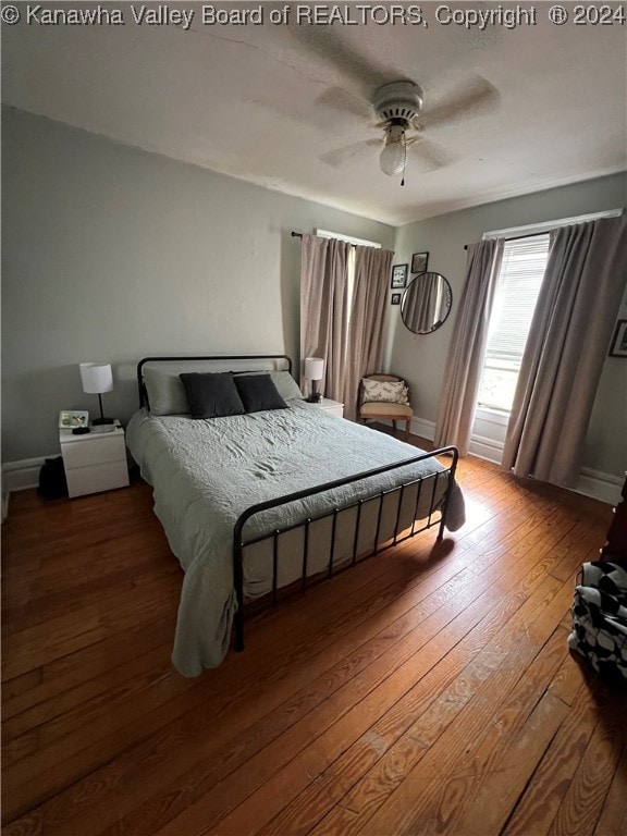 bedroom with wood-type flooring and ceiling fan