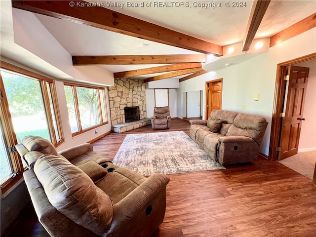 living room with vaulted ceiling with beams, wood-type flooring, and a fireplace