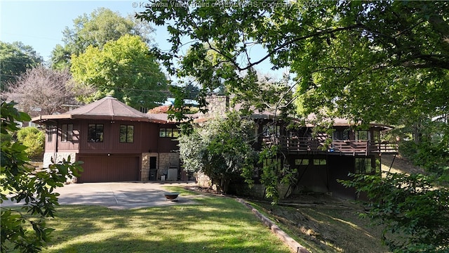 view of yard featuring a garage and a deck