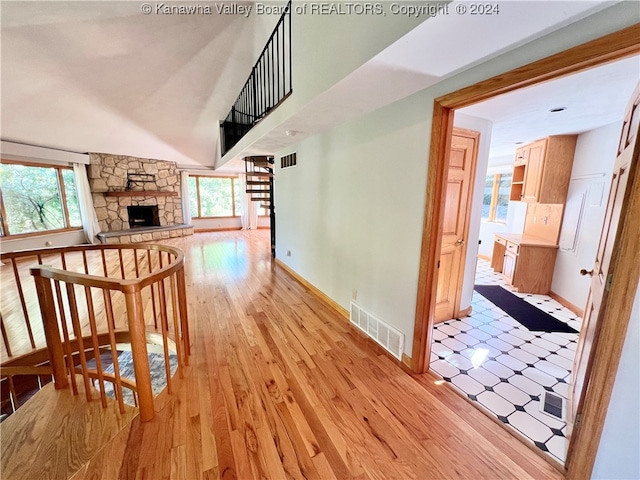 hall featuring light hardwood / wood-style flooring and a wealth of natural light