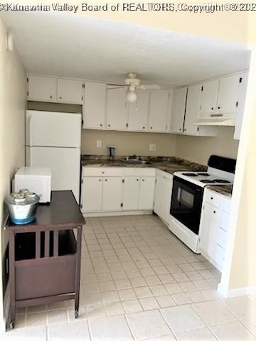 kitchen featuring light tile patterned floors, white appliances, white cabinetry, and ceiling fan