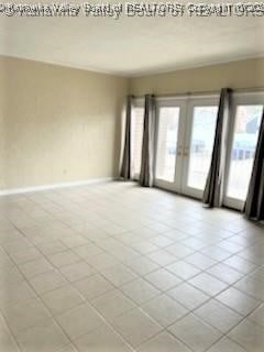 spare room featuring french doors