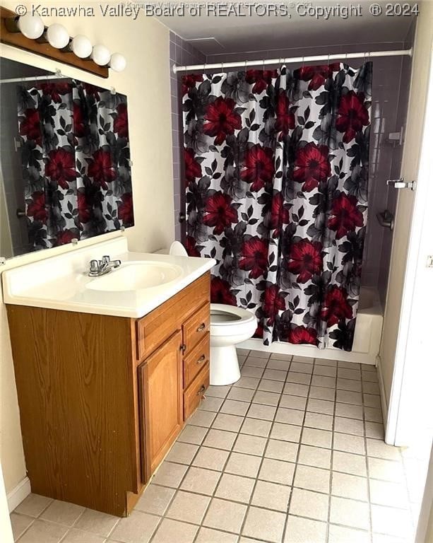 full bathroom with vanity, tile patterned floors, toilet, and shower / bath combo