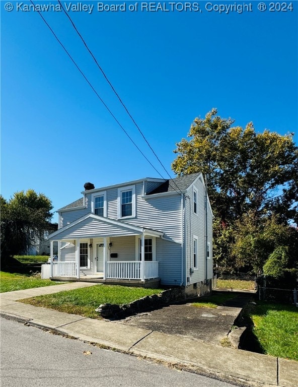 view of front of house with a porch and a front lawn