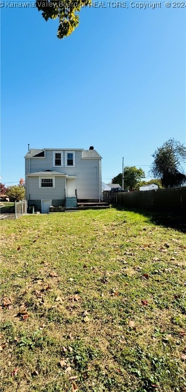 back of house with a yard