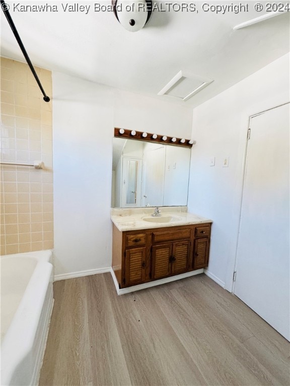 bathroom featuring vanity, hardwood / wood-style floors, and shower / bath combination