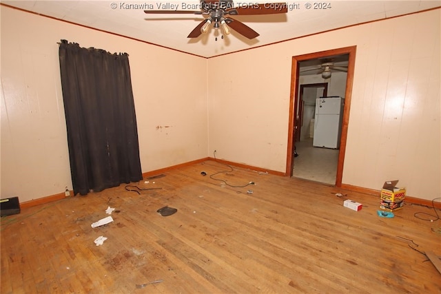 empty room with ceiling fan and light hardwood / wood-style floors