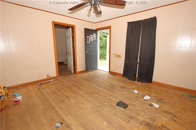 empty room with ceiling fan and light hardwood / wood-style floors