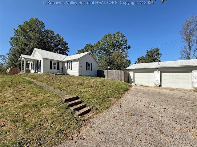 view of side of home with a garage and a lawn