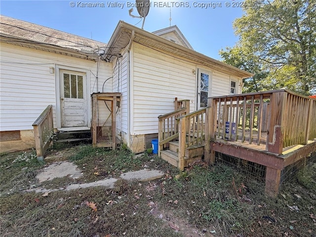 back of house with a deck