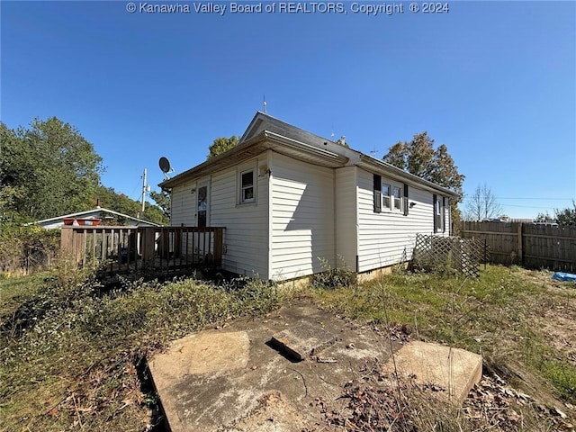 view of property exterior featuring a wooden deck