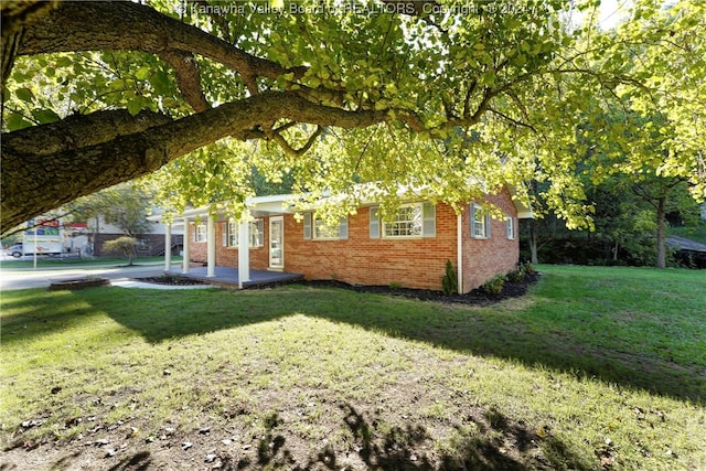 view of side of home with a yard