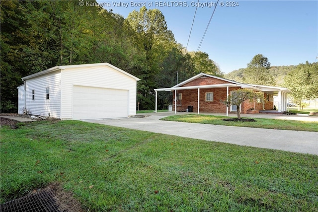 view of front of house with a garage, a carport, an outdoor structure, and a front lawn