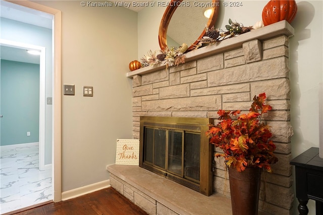 interior details featuring a fireplace and hardwood / wood-style flooring