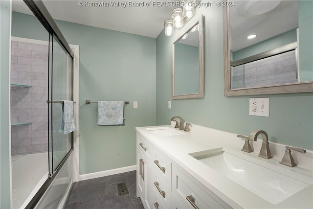 bathroom featuring combined bath / shower with glass door, vanity, and tile patterned floors