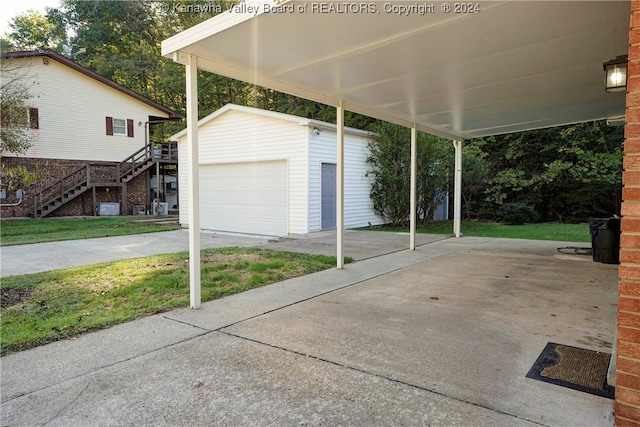 view of patio / terrace with an outdoor structure and a garage