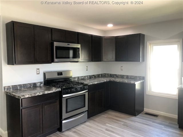 kitchen featuring stainless steel appliances and light hardwood / wood-style floors